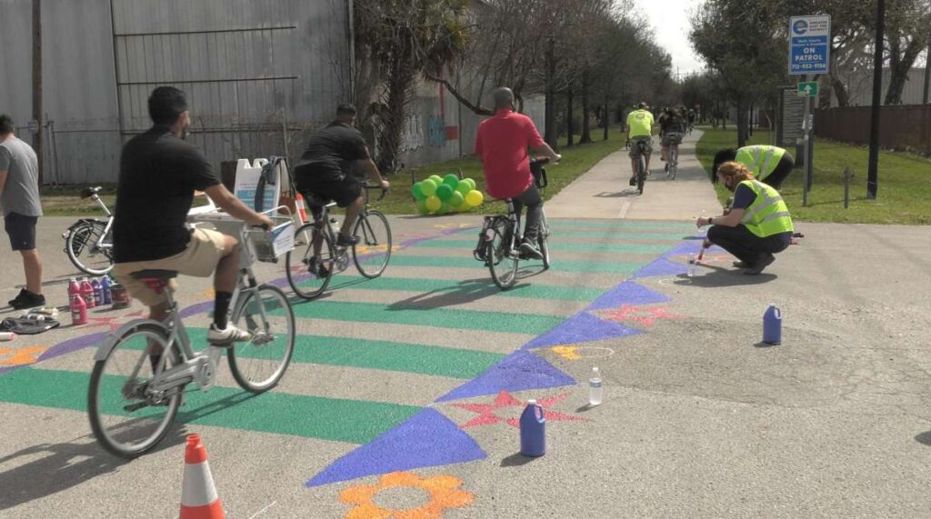 Photo of community members biking into the Harrisburg Hike and Bike Trail on the pop-up bike lane