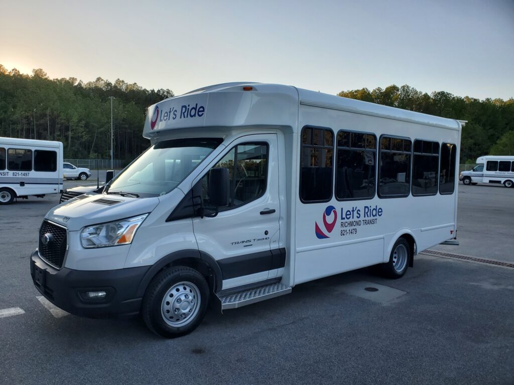 a white microtransit vehicle with the Richmond Transit logo and "Let's Ride" on the side