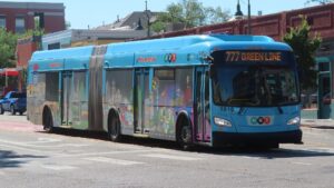 A bus pulling up to an intersection. 