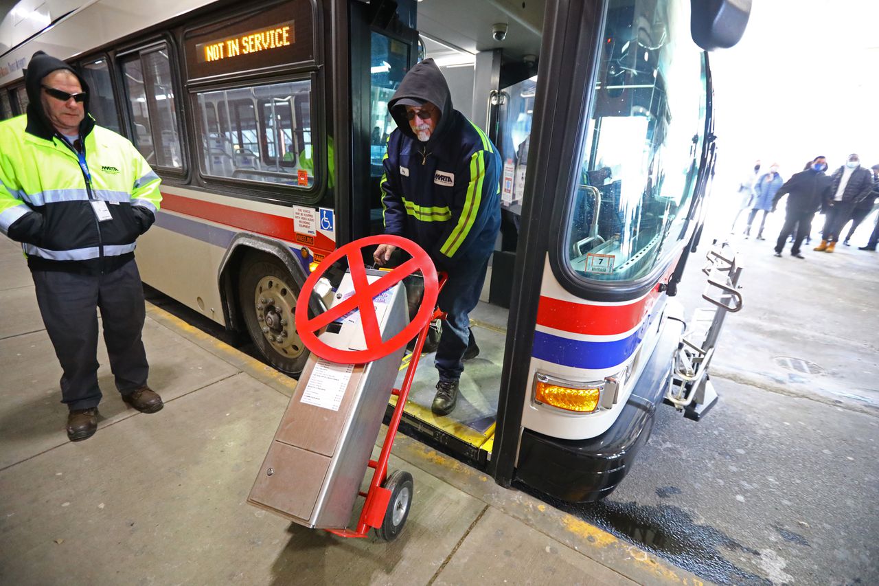 Image of MVRTA property manager removing the last fare box from a bus
