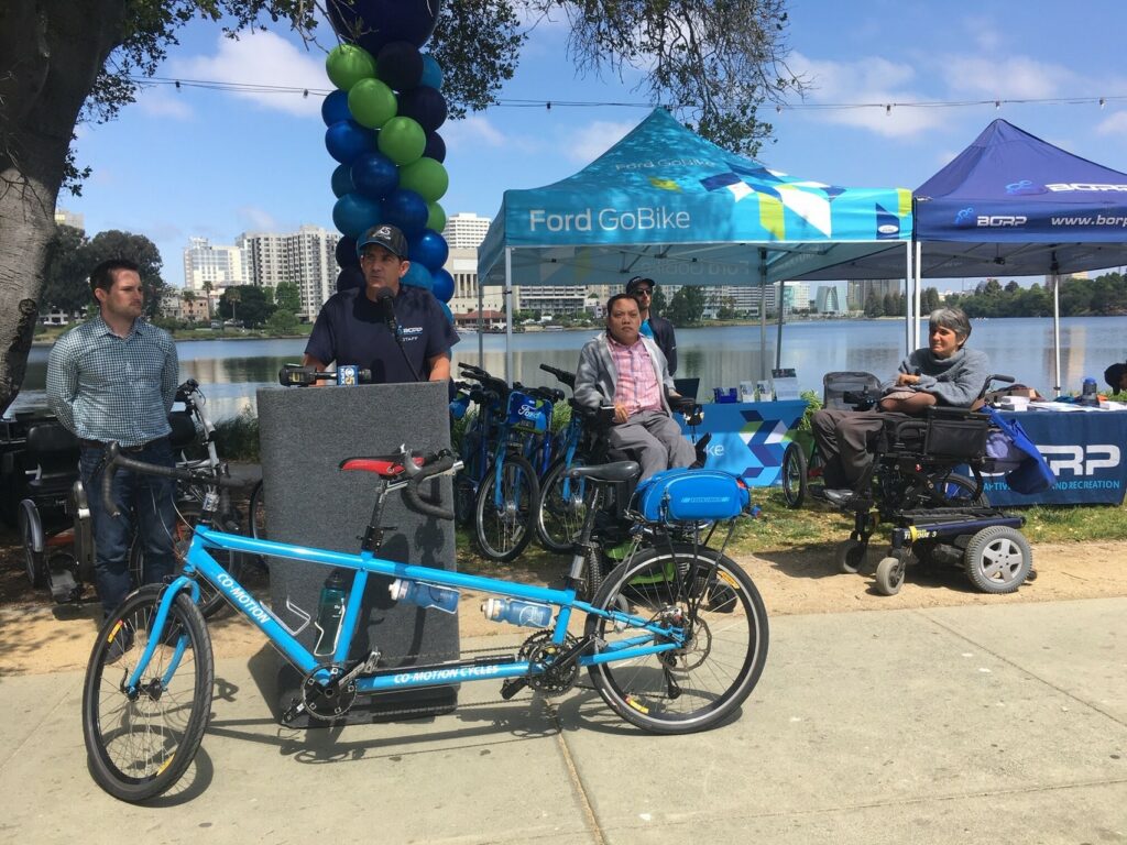 Shows launch of Oakland adaptive bikeshare, with some of the vehicles