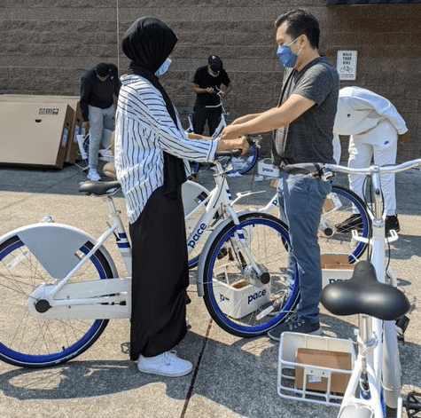 Image of people assembling bicycles for giveaway and outreach event