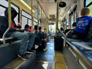 Passengers sit riding a bus.