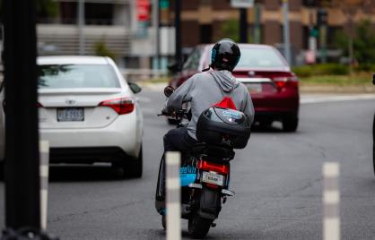 Image of person using moped