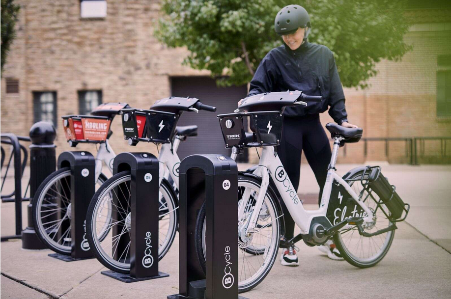 Image of person at BCycle bikeshare dock with bicycles
