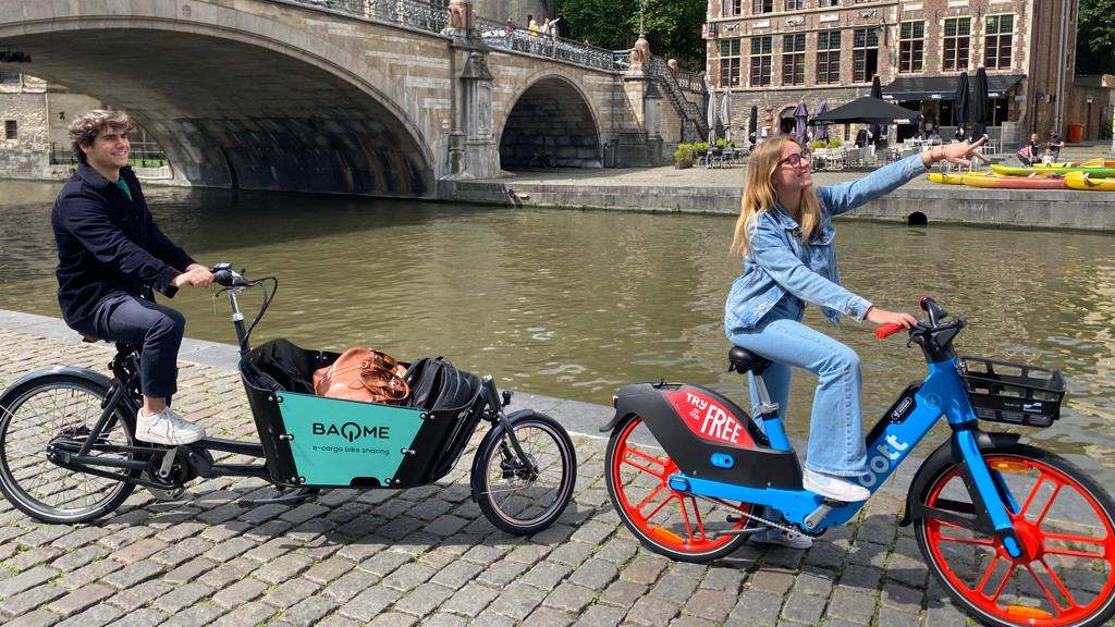 Image of persons riding a BAQME cargo bike and a Dott e-bike