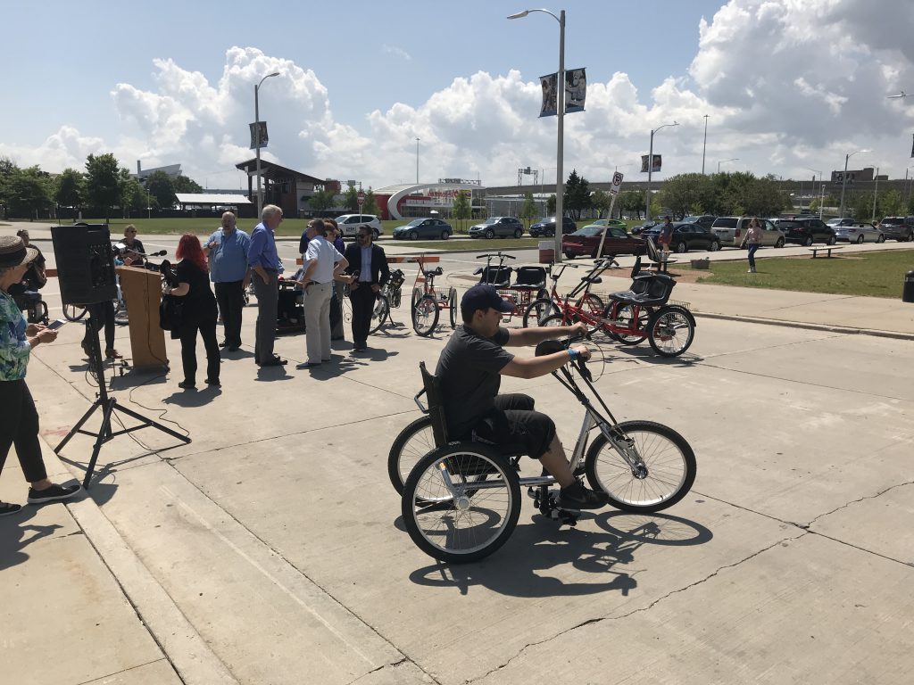A group of people test adaptive bikes.