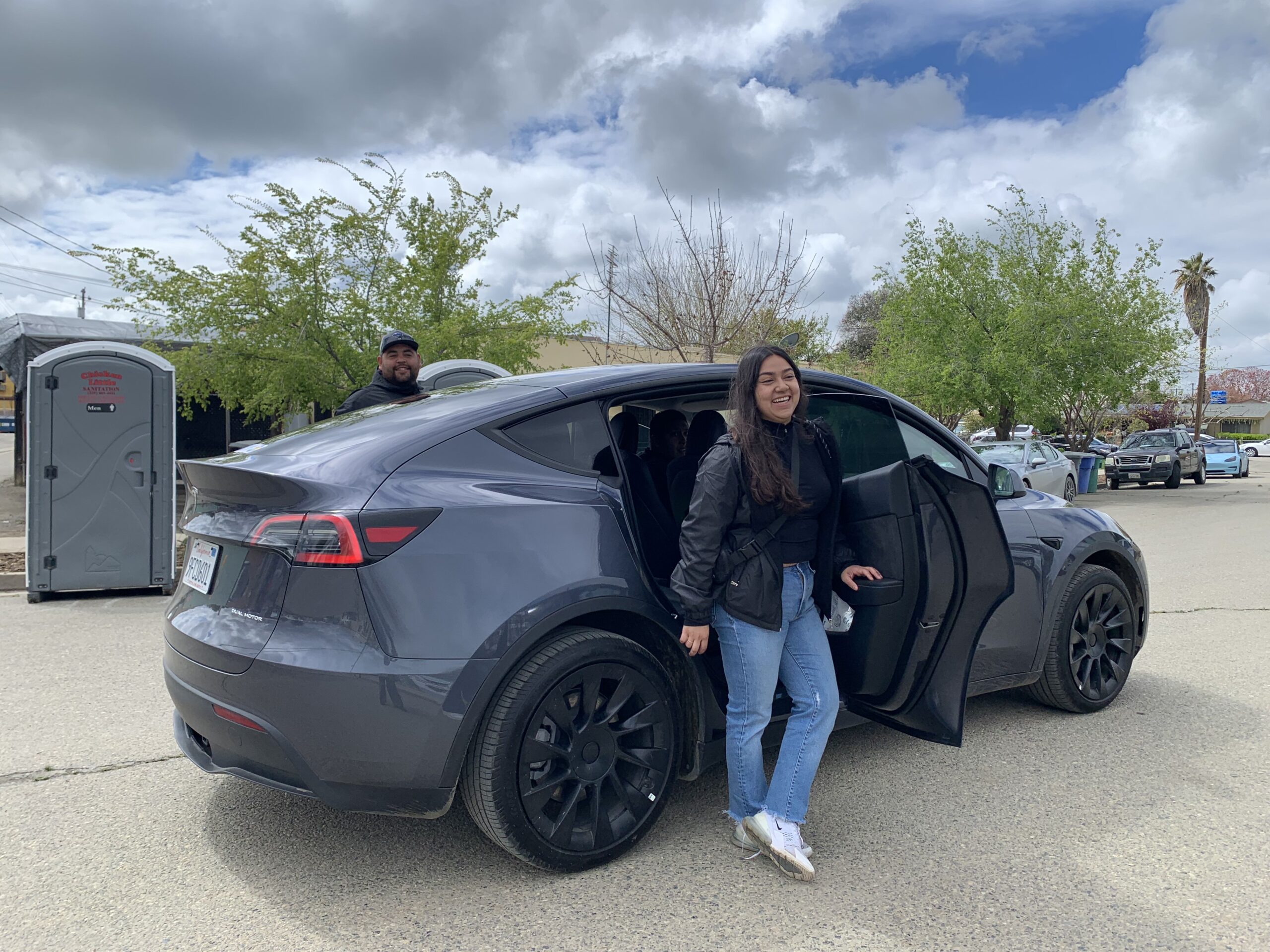 Two passangers alighting a electric vehicle in Huron, California