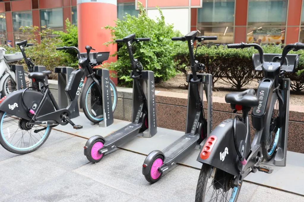 Bikes and scooters docked at a shared mobility station