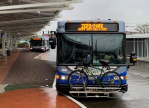 A bus pulling away from a bus depot. 