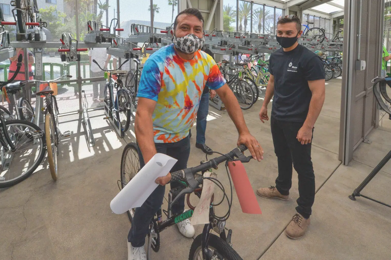 Image of participant receiving bicycle through Adopt-a-Bike