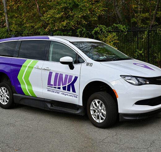 a parked purple and white van with LINK on the side