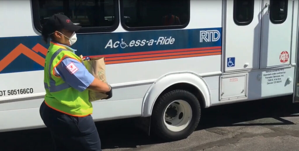 RTD bus operator carrying a bag of groceries.