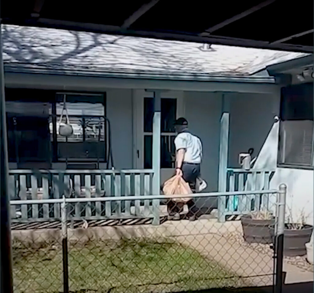 RTD operator carrying groceries to a house.