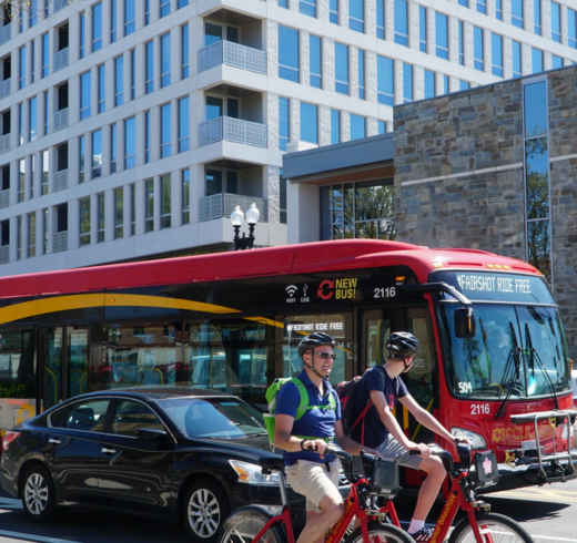 Image of users on Capitalb Bikeshare system with DC Circulator bus in background