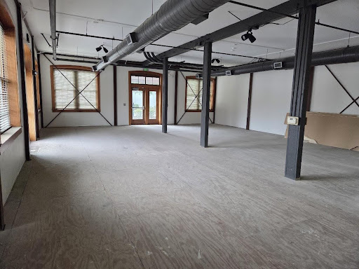 an empty room with a door at the far end