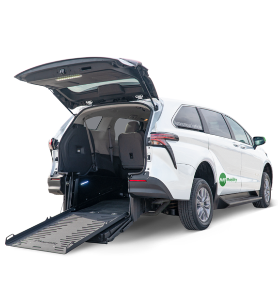 A white minivan with the trunk open and a wheelchair ramp extended