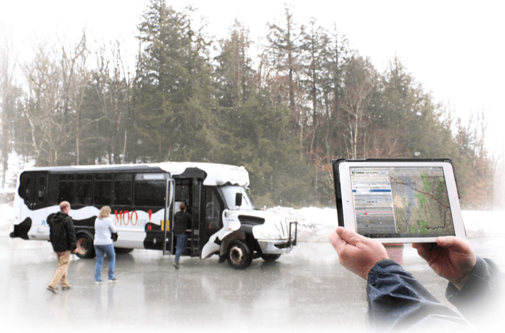 Trip Planner tool displayed on tablet in front of VT Moover bus