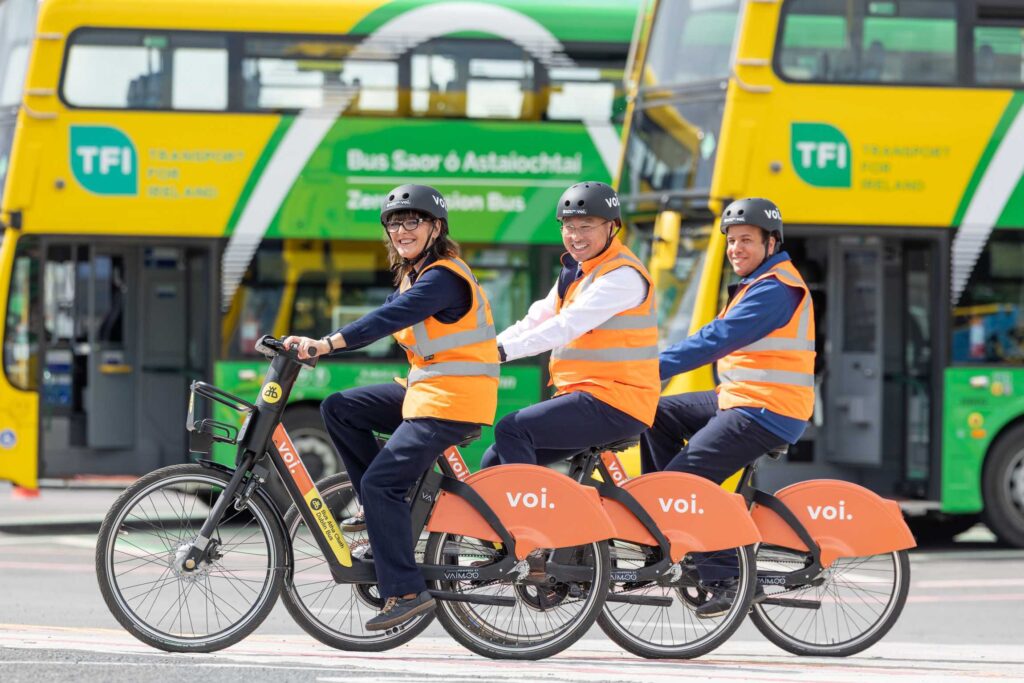Image of Dublin Bus Employees riding Voi e-bikes