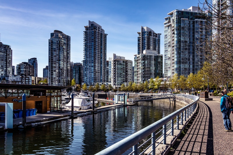 Waterfront walkway in Vancouver leading to new midrise and highrise developments