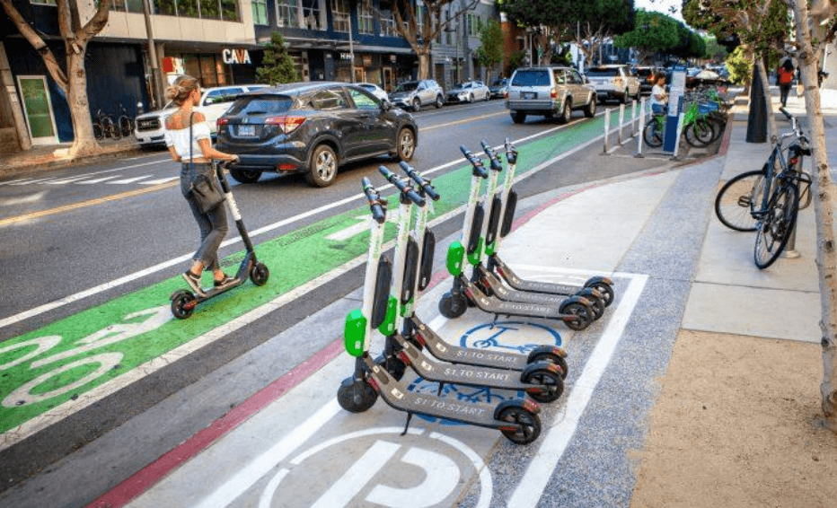 Photo of scooters parked in a designated scooter coral (box painted on the street)