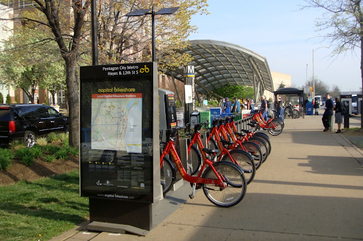 Bikeshare dock located near a transit station.