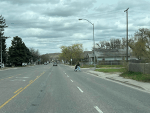 two people run across a street