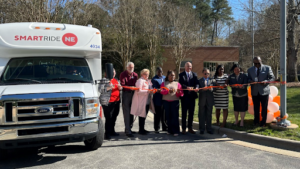 Wake County officials stand by a SmartRide van at a ribbon cutting ceremony