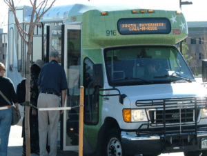 Photo of call-n-ride shuttle and peole boarding.