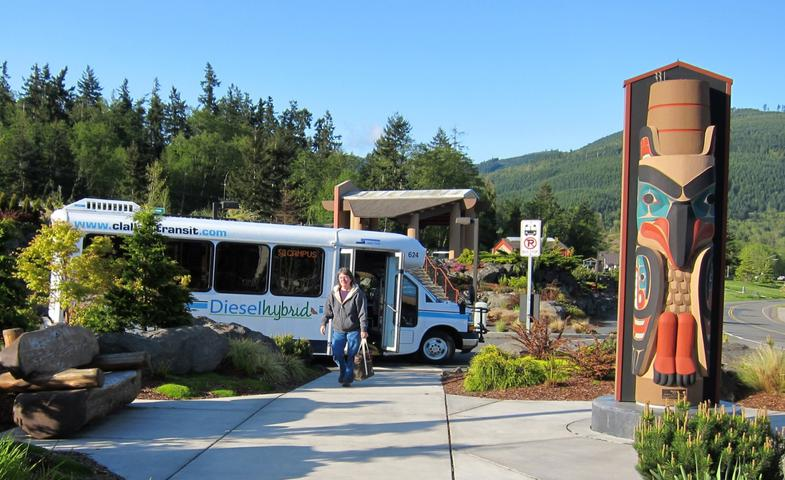 a bus parked next to a totem pole