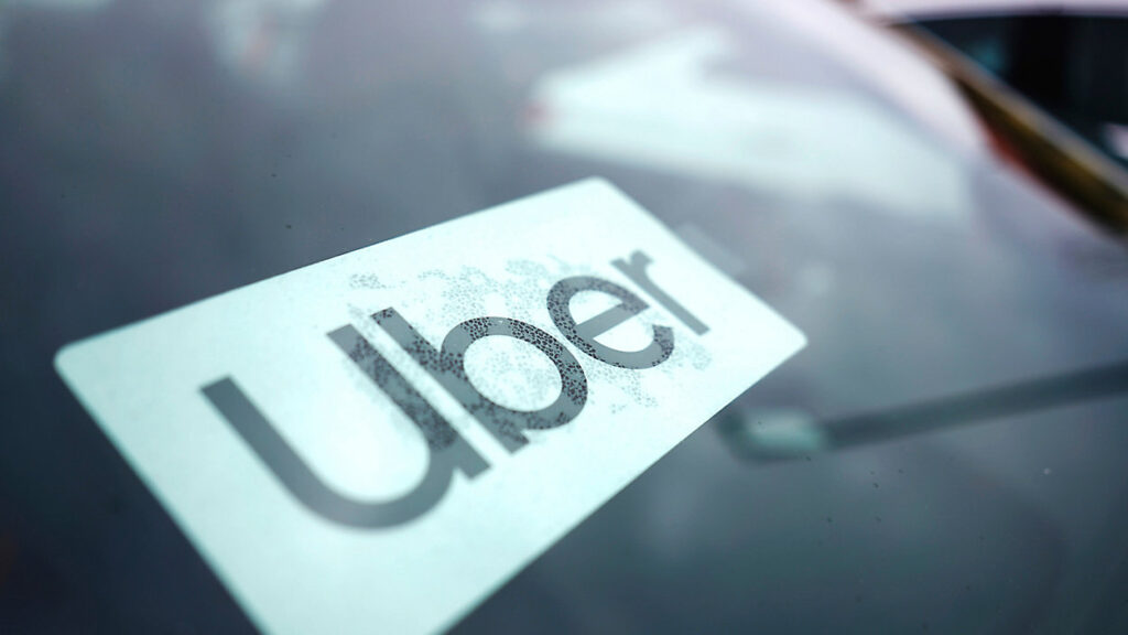 Image of the Uber logo on a windshield with Rain