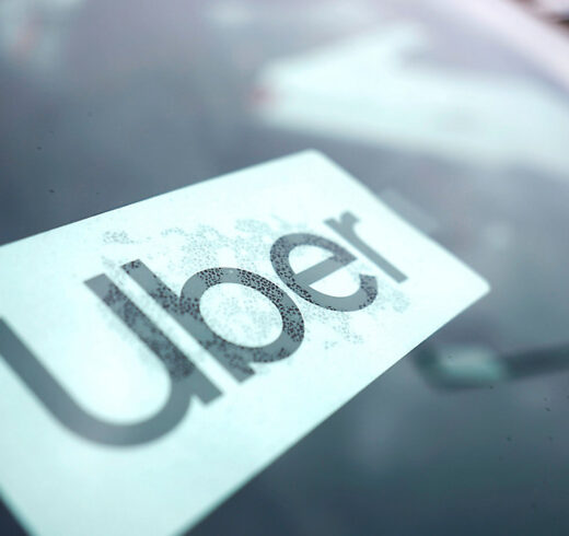Image of the Uber logo on a windshield with Rain